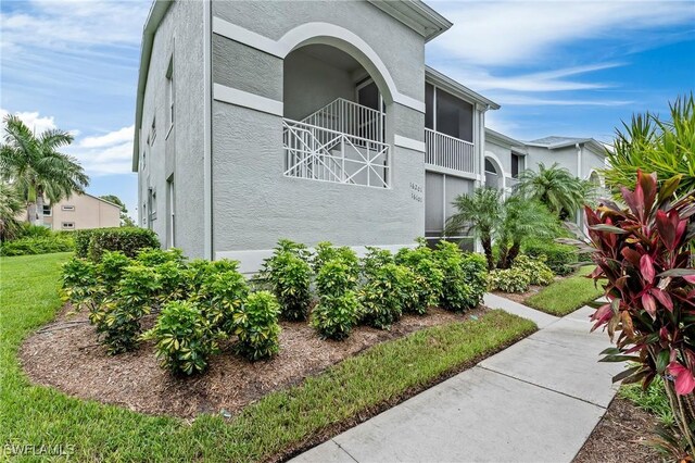 view of side of home featuring a balcony