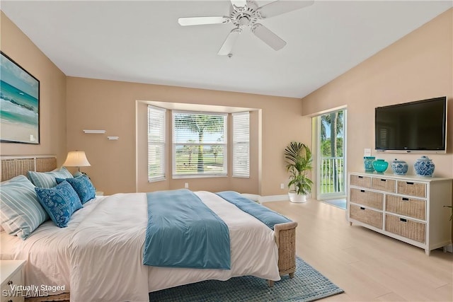 bedroom featuring access to exterior, light wood-style flooring, a ceiling fan, vaulted ceiling, and baseboards