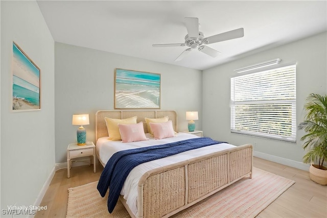 bedroom featuring light wood-type flooring, ceiling fan, and baseboards