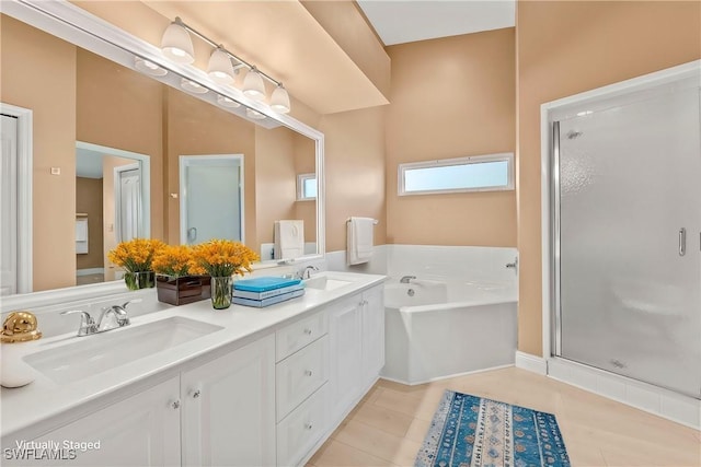 bathroom with double vanity, a stall shower, a sink, and a bath