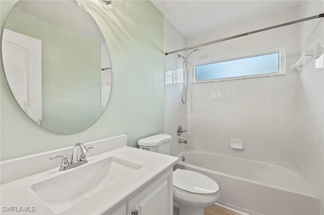 bathroom featuring toilet, tub / shower combination, and vanity