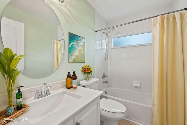 full bathroom featuring toilet, vanity, and shower / tub combo with curtain