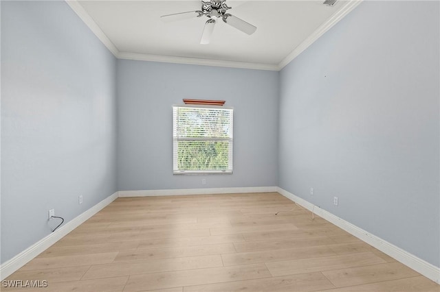 unfurnished room featuring light wood-type flooring, a ceiling fan, baseboards, and crown molding