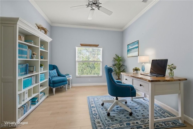 office featuring ceiling fan, light wood-style flooring, visible vents, baseboards, and ornamental molding