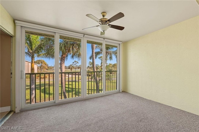 unfurnished sunroom featuring a ceiling fan and a healthy amount of sunlight