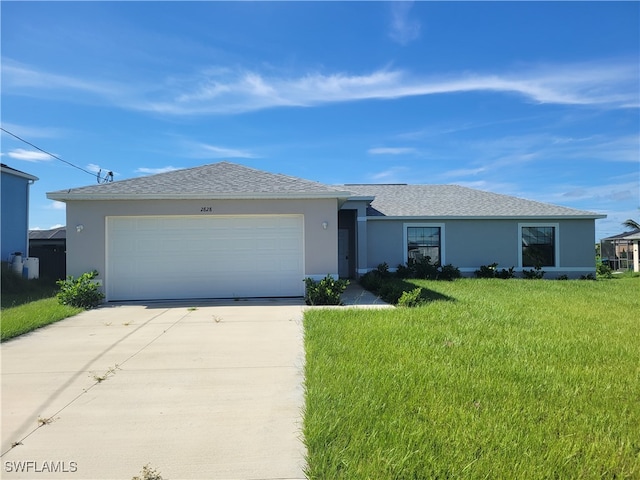 ranch-style house featuring a garage and a front lawn