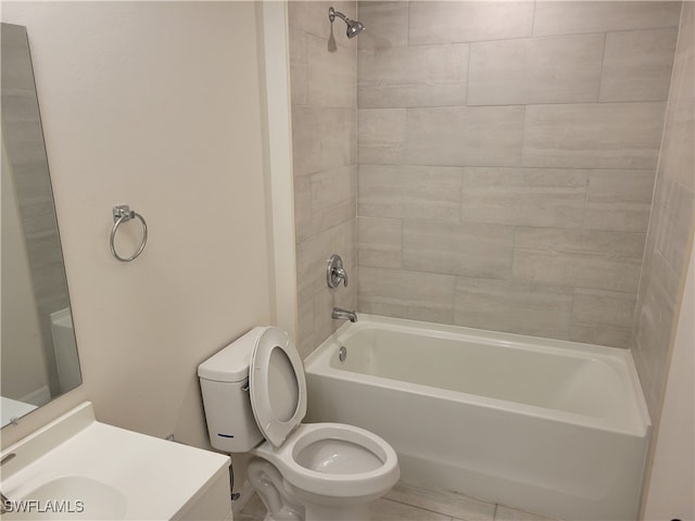 full bathroom with tiled shower / bath, toilet, and vanity