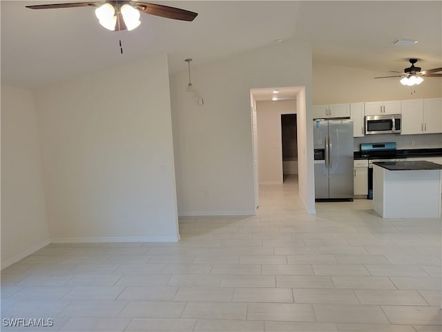 kitchen with white cabinets, appliances with stainless steel finishes, lofted ceiling, and ceiling fan