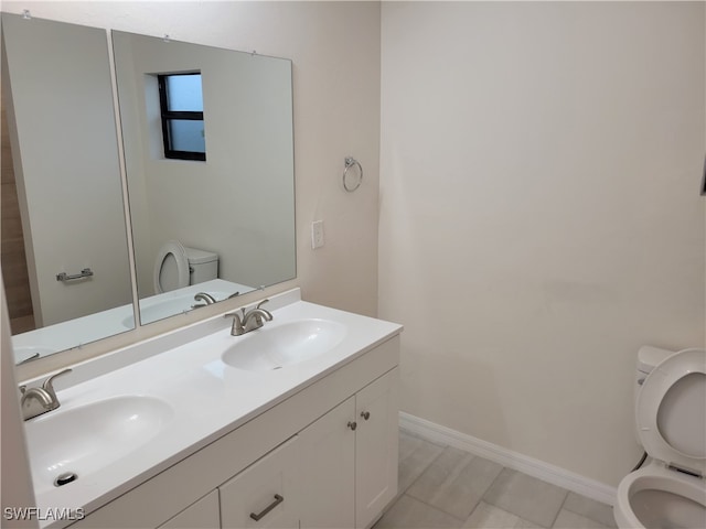 bathroom with vanity, toilet, and tile patterned floors