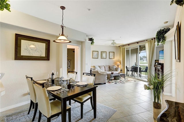 dining space featuring light tile patterned floors, baseboards, and ceiling fan