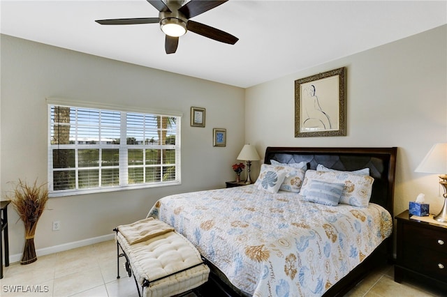 tiled bedroom featuring baseboards and ceiling fan