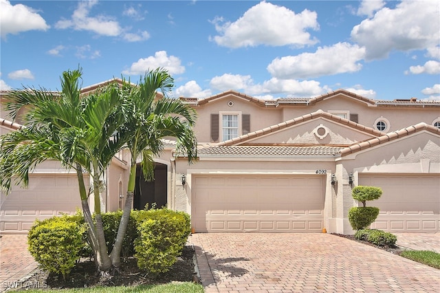 mediterranean / spanish-style house with a garage