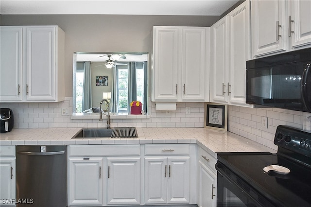 kitchen with black appliances, ceiling fan, sink, and white cabinets