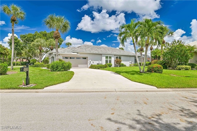 view of front of house featuring a front yard and a garage