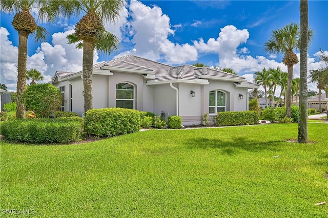 mediterranean / spanish house featuring a front lawn