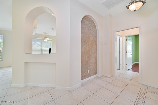 hall featuring light tile patterned floors