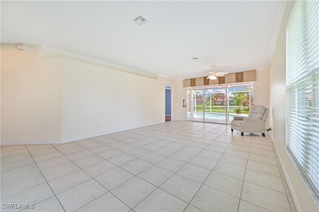 interior space with ceiling fan, ornamental molding, and light tile patterned floors