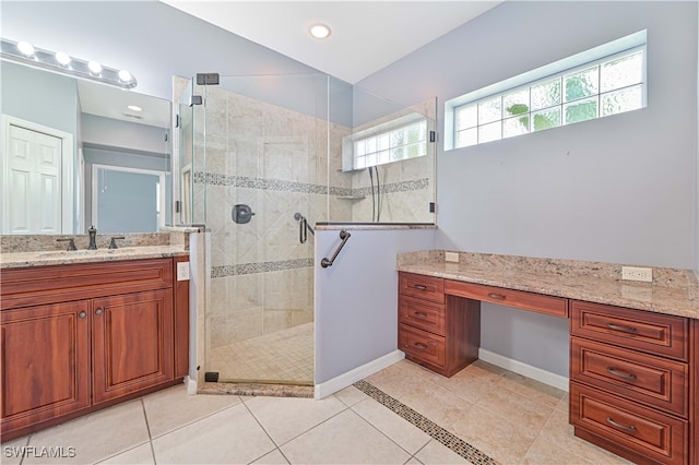 bathroom with vanity, tile patterned flooring, and a shower with door