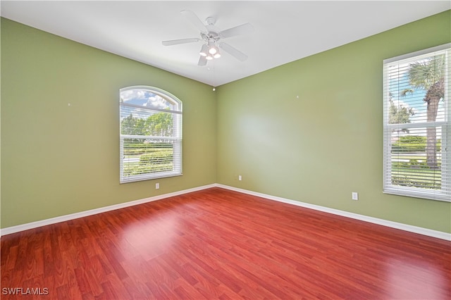 unfurnished room with ceiling fan and wood-type flooring