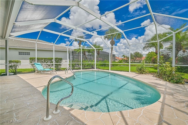 view of pool featuring a patio area and glass enclosure