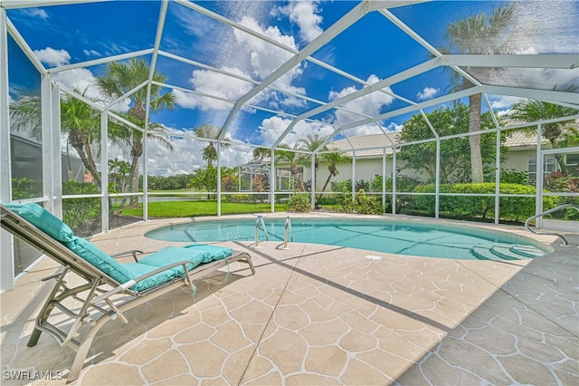 view of swimming pool featuring a patio area and a lanai