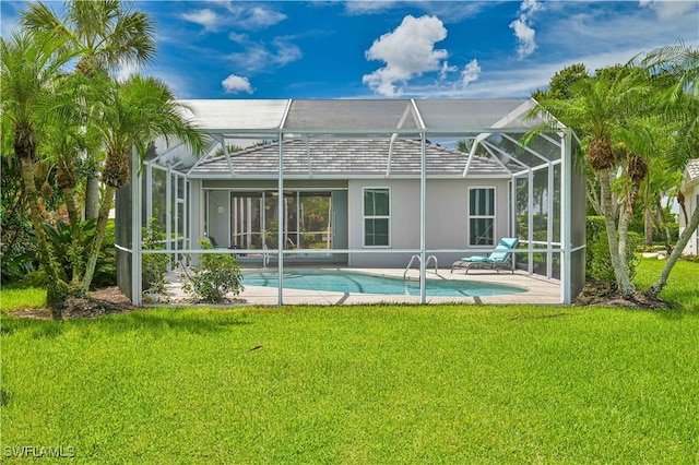 back of property featuring a patio area, a lawn, and glass enclosure