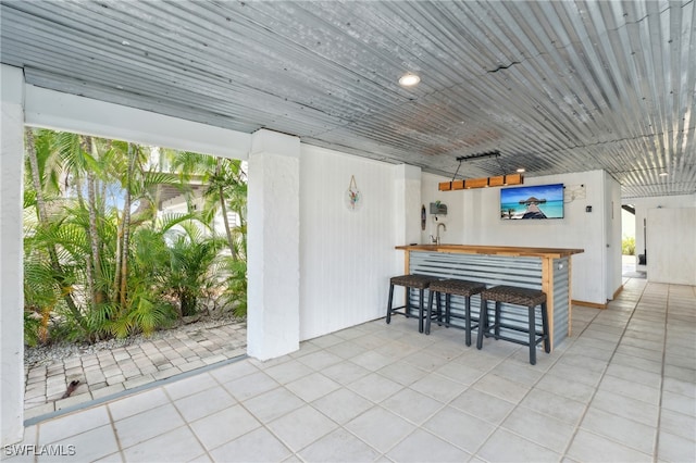 view of patio / terrace featuring outdoor dry bar and a ceiling fan