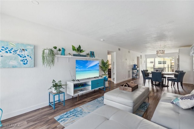 living room with baseboards and wood finished floors