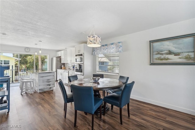 dining area featuring a textured ceiling, baseboards, and dark wood-style flooring