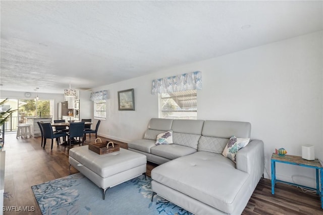 living area featuring dark wood-type flooring and baseboards