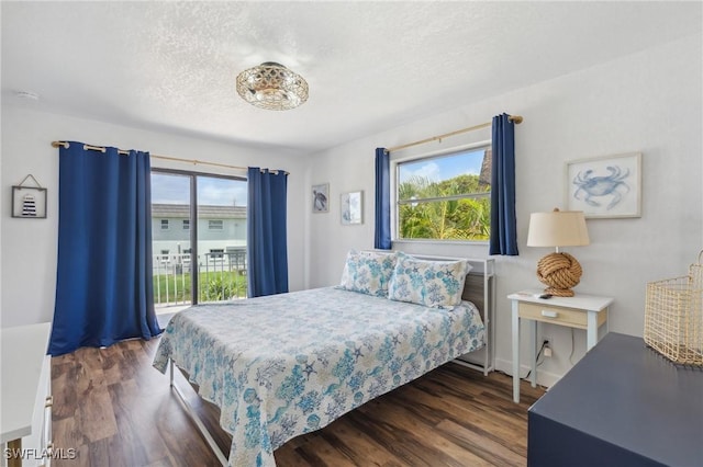 bedroom featuring a textured ceiling and dark wood-type flooring