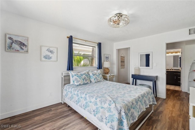 bedroom with dark wood finished floors, visible vents, and baseboards