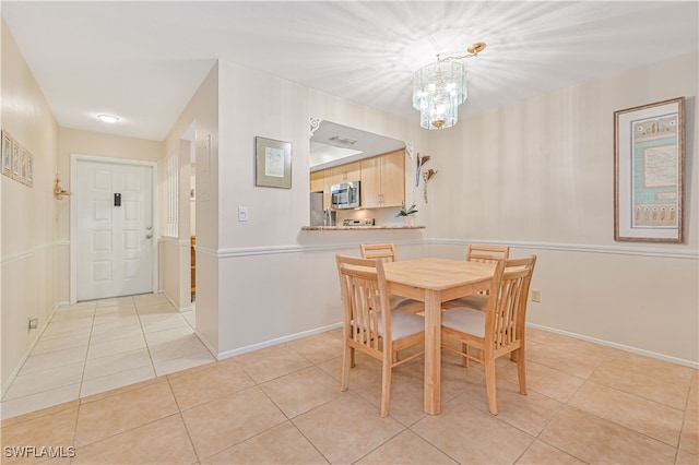 tiled dining area featuring a notable chandelier