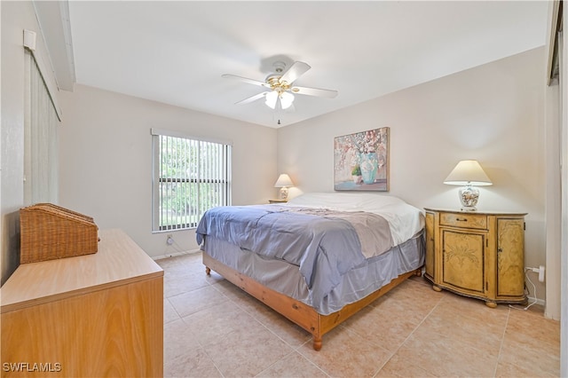 bedroom with ceiling fan and light tile patterned floors