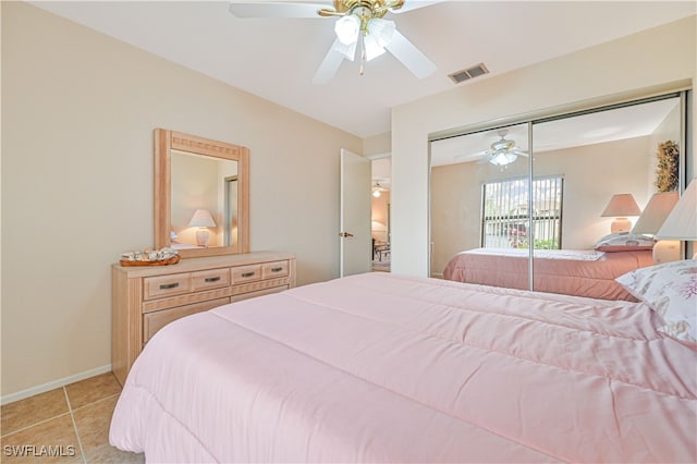 tiled bedroom with a closet and ceiling fan