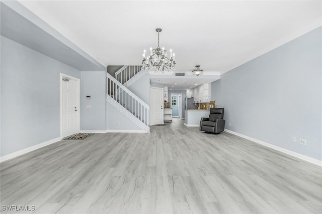 unfurnished living room with light wood-style floors, visible vents, stairway, and baseboards