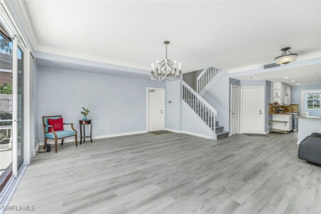 living room featuring an inviting chandelier and light hardwood / wood-style floors