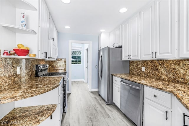 kitchen featuring appliances with stainless steel finishes, light wood-type flooring, white cabinets, and open shelves