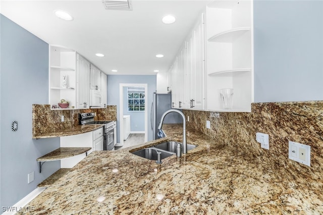 kitchen featuring stainless steel appliances, a sink, white cabinetry, visible vents, and open shelves