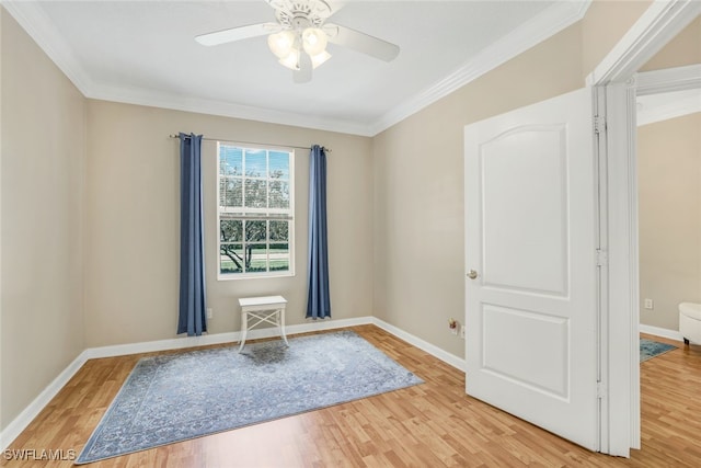 unfurnished room featuring crown molding, baseboards, and light wood-style floors