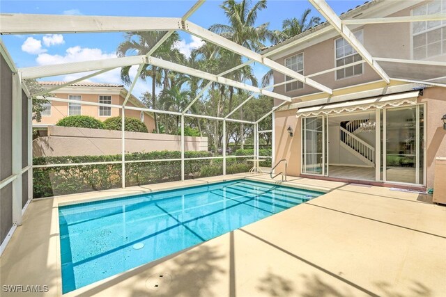 view of pool featuring a fenced in pool, glass enclosure, a patio area, and fence