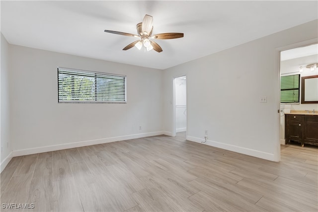 spare room featuring ceiling fan and light wood-type flooring