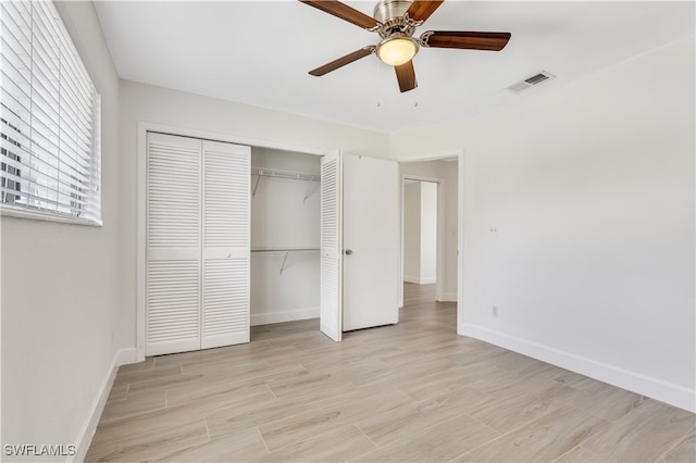 unfurnished bedroom featuring ceiling fan, a closet, and light hardwood / wood-style floors