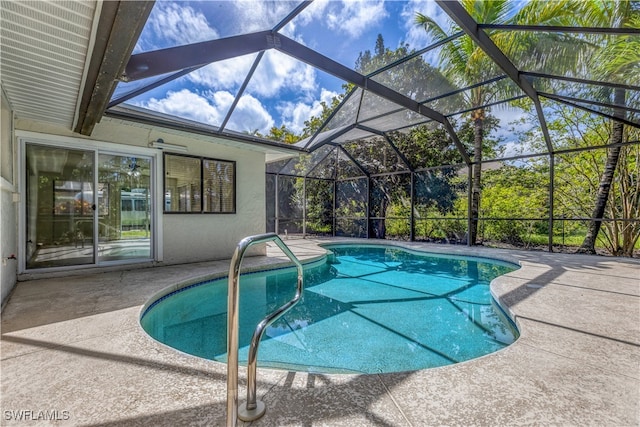 view of swimming pool with a lanai and a patio area