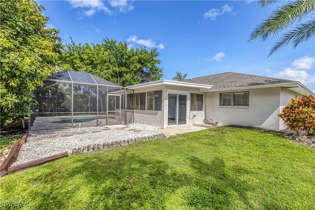 rear view of property with glass enclosure, a lawn, and a patio