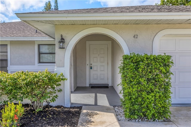 doorway to property with a garage