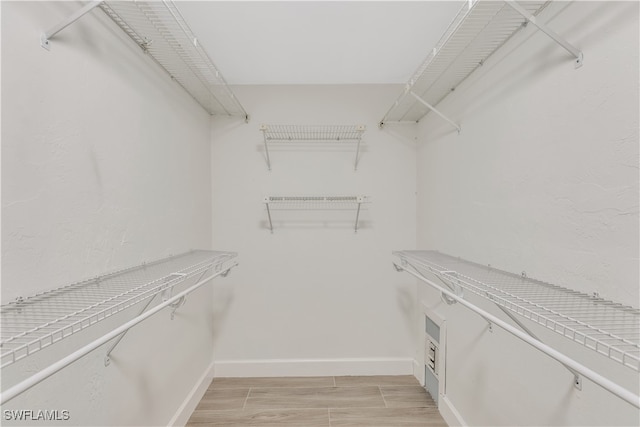 spacious closet featuring light hardwood / wood-style floors