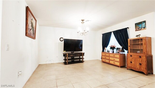 tiled living room with a chandelier