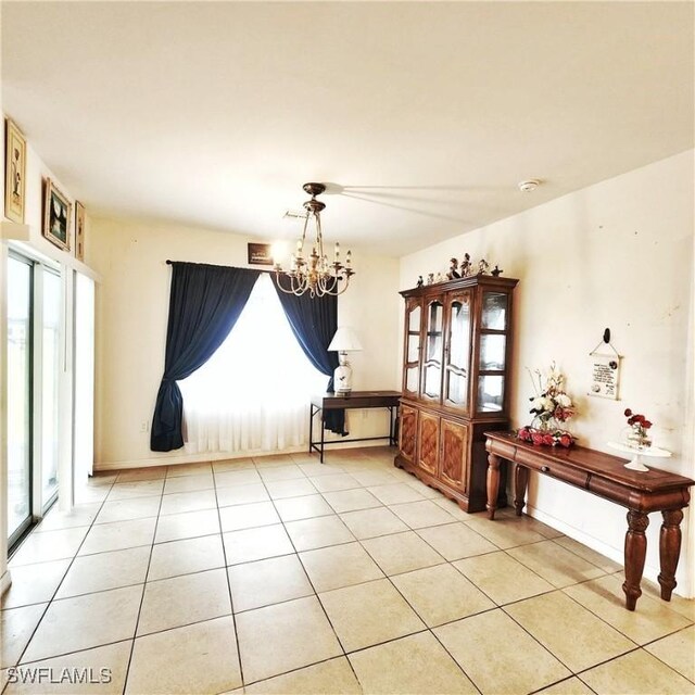 unfurnished dining area with a healthy amount of sunlight, a notable chandelier, and light tile patterned flooring