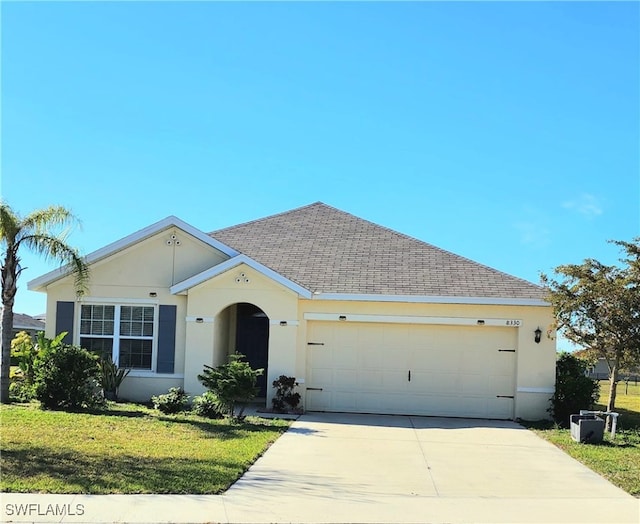 ranch-style house featuring a front lawn and a garage